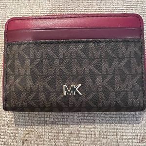 Small wine colored GENTLY USED Michael Kors zip around wallet